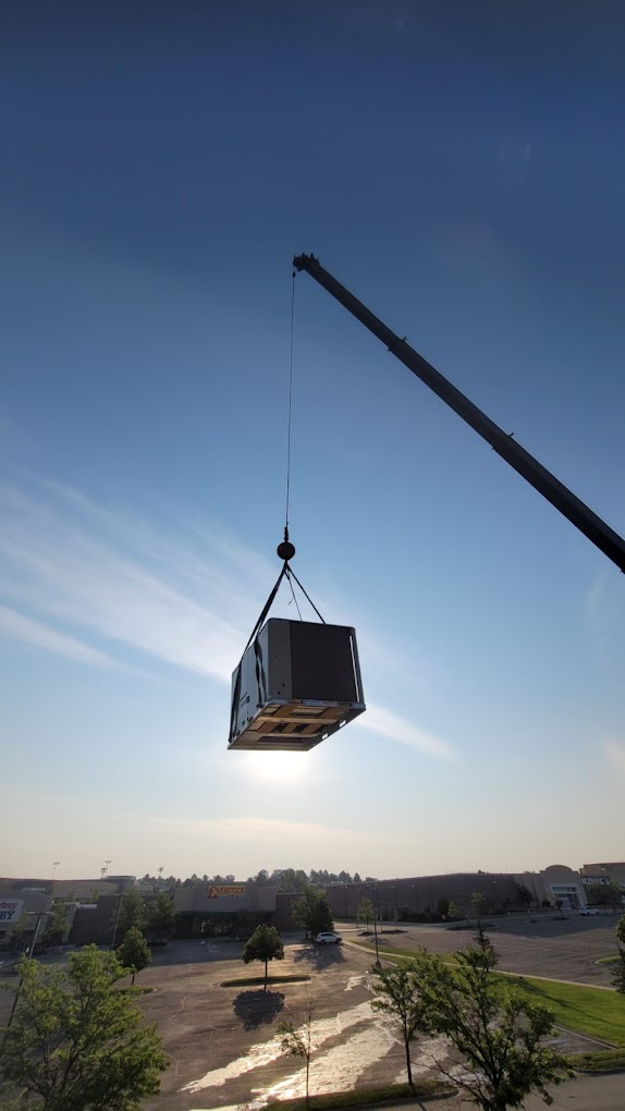 Rooftop unit being lifted into place
